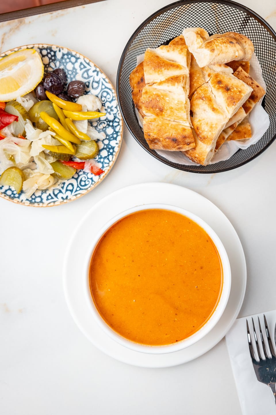 Red lentil soup with pickles and fresh bread