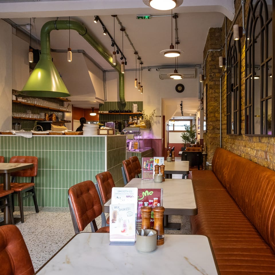 The dining room at Hanımeli with the green-tiled counter and open kitchen