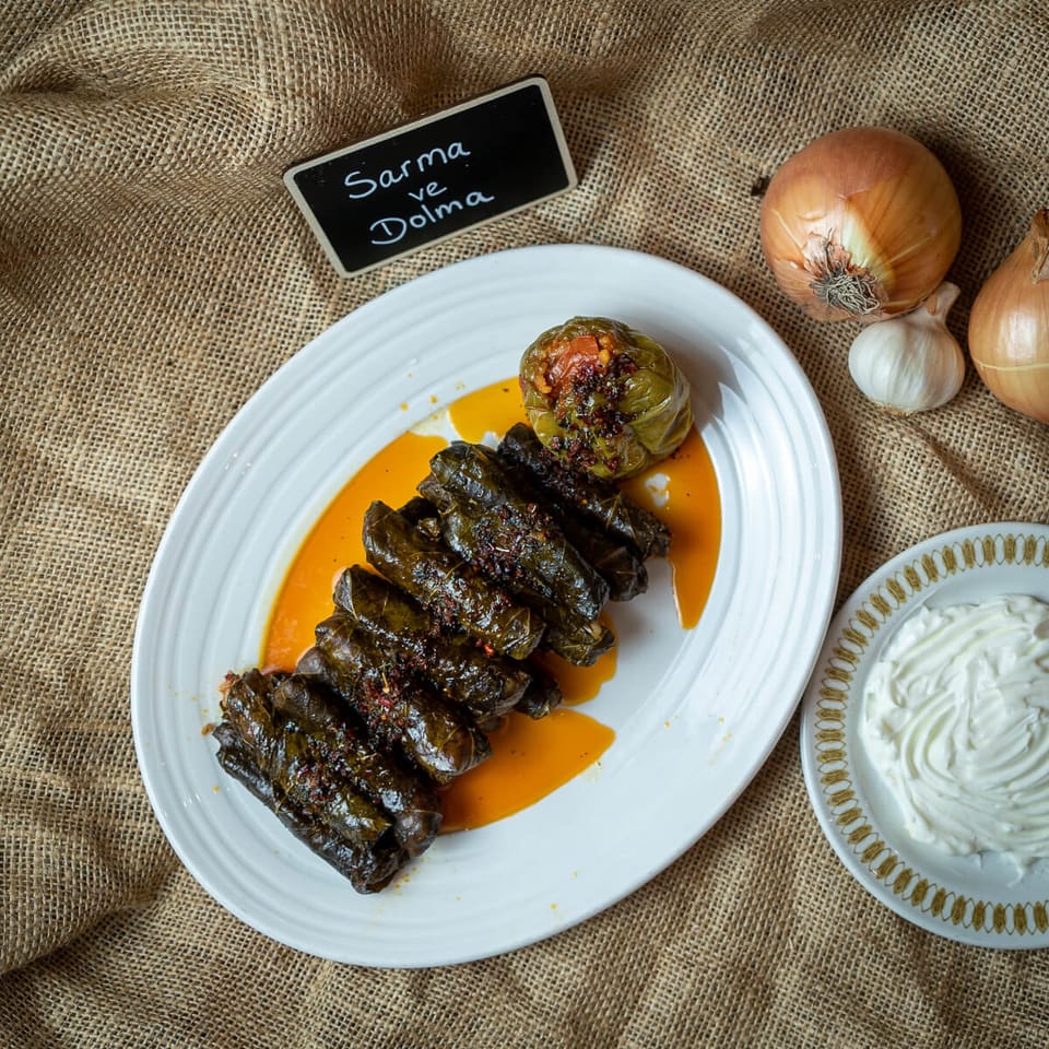 Sarma Dolma — Vine leaves rolled by hand, served with yoghurt