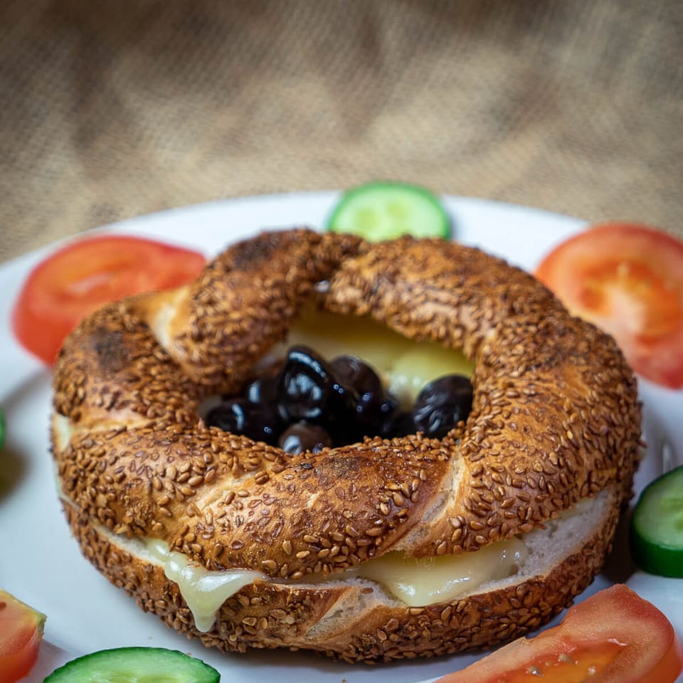 Fresh simit with cheese, tomatoes and cucumber
